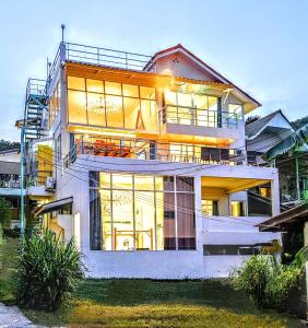 a large house with a lot of windows at Beach Front Queen's Castle - Kid friendly, Holiday like Royalty in Ban Ao Makham