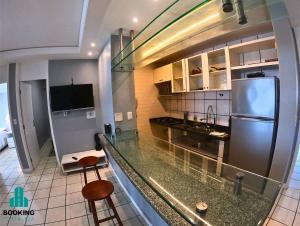 a kitchen with a counter top and a refrigerator at Estoril Praia de Iracema in Fortaleza
