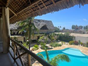 a view from the balcony of a resort with a swimming pool at The Garden in Paje