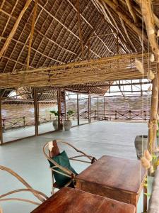 a room with a table and a chair in a building at The Garden in Paje