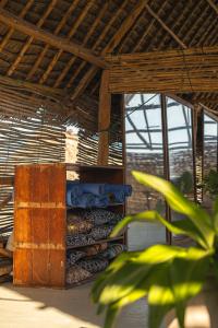 a building with a stack of wood at The Garden in Paje