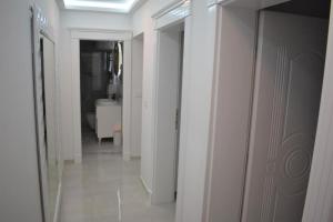 a hallway of a bathroom with a sink and a toilet at Moco - Novalja in Novalja +25 photos