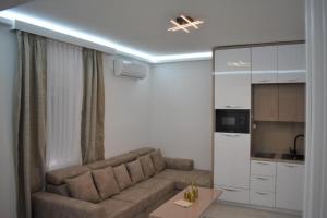 a living room with a couch and a kitchen at Moco - Novalja in Novalja