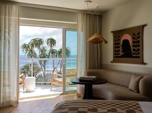 a living room with a couch and a view of the ocean at Casa Loma Beach Hotel in Laguna Beach