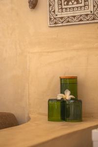 a green box with a white flower on a table at The Garden in Paje