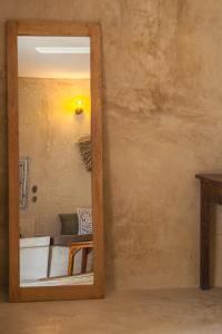 a mirror in a room with a couch and a table at The Garden in Paje