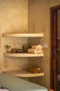 a shelf in a room with towels on it at The Garden in Paje