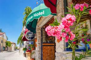 a building with pink flowers on the side of it at Ceran Stone House in Nevsehir