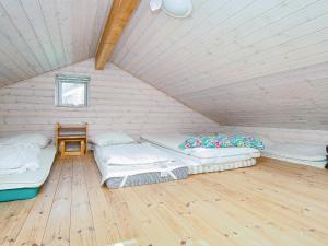 a room with three beds in a attic at 9 person holiday home in Jægerspris-By Traum in Jægerspris