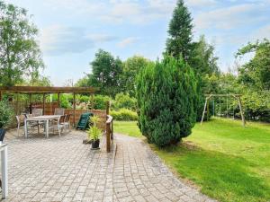 a patio with a table and a gazebo at 9 person holiday home in Jægerspris-By Traum in Jægerspris