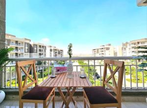 a wooden table and two chairs on a balcony at luxury Heaven 2 in Madinaty