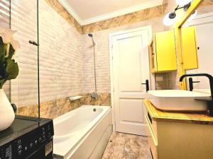 a bathroom with a white tub and a sink at luxury Heaven 2 in Madinaty +30 photos