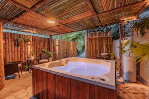 a large bath tub in a room with wooden ceilings at Ecohotel Piedemonte in Salento