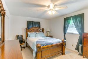 a bedroom with a bed and a ceiling fan at Cozy Waycross House with Yard and Screened Patio! in Waycross