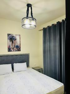 a bedroom with a bed and a chandelier at Porto Sharm elsheikh-Aqua park view in Sharm El Sheikh