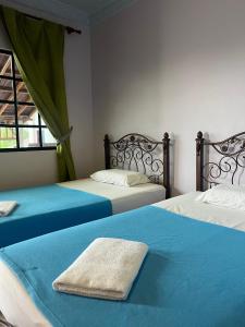 Ένα ή περισσότερα κρεβάτια σε δωμάτιο στο Kanza Beach Inn