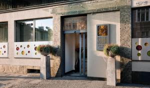 a store front with the door open with potted plants at Soleil Boutique H in Sopot