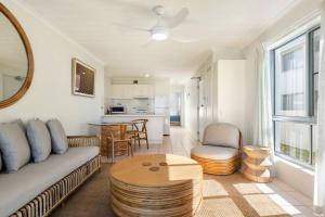 a living room with a couch and a table at Absolute Beachfront Apartment 11B in Lennox Head