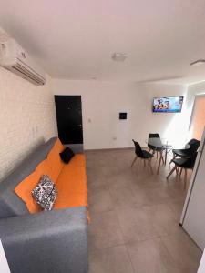 a living room with a couch and a table at Departamentos del Norte in Fray Luis Beltrán