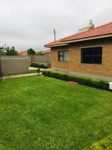 a yard in front of a house with a frisbee at Kwakwethu in Bulawayo