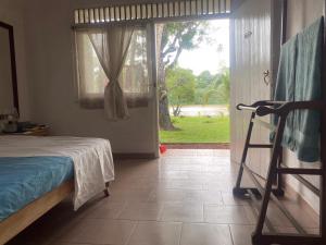 a bedroom with a bed and a sliding glass door at riVer in Pelena