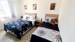 two beds in a room with white walls at Cantinho da Bell in Araruama +52 photos