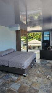 a bedroom with a bed and a large window at Lydia's House in Kaputian