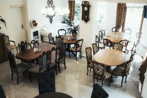a dining room with wooden tables and chairs at Chałpa z bali in Zakopane +17 photos
