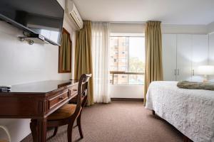 Postel nebo postele na pokoji v ubytování Apart Hotel San Martin