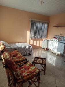 a living room with a couch and a bed at chalés duas irmãs in Serra Negra +37 photos