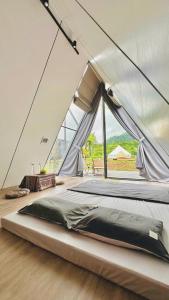 a bedroom with a large bed in a tent at Ora Hill Retreat in Cao Phong