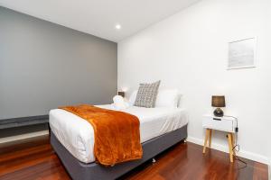 a bedroom with a bed with a blanket on it at 2BR Apt Near Parliament House - Hosted by Canstay in Kingston 