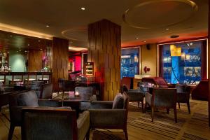 a restaurant with chairs and tables and a bar at Radisson Collection Hyland Shanghai in Shanghai