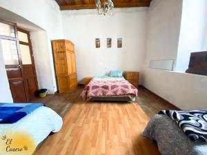 a bedroom with two beds and a wooden floor at MiniDepa Centrico in Cajamarca