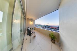 a balcony with a table and a view of a city at Comfort Zone Suites - Hidas in Windhoek