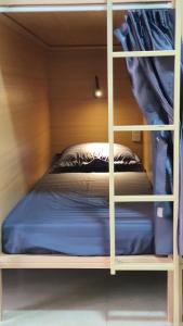 a bunk bed with a blue mattress in a room at Nhat Sapa Hostel in Sapa