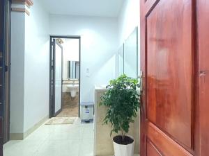 a bathroom with a potted plant next to a door at Nhat Sapa Hostel in Sapa