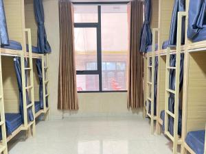 a row of bunk beds in a room with a window at Nhat Sapa Hostel in Sapa +38 photos