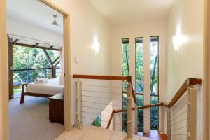 a room with a staircase and a bed and a window at The Savannah Villa in Port Douglas +21 photos