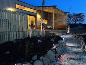 a house with lights on the side of it at Alpine Chalet - views, fire-pit, central, cosy in Wanaka