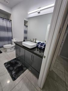 a bathroom with a sink and a toilet at Beautiful apartment 9 min to Mercedes outlets in Weslaco