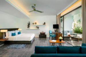 a bedroom with a bed and a living room at Viroth's Hotel in Siem Reap