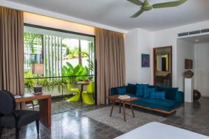 a living room with a blue couch and a table at Viroth's Hotel in Siem Reap