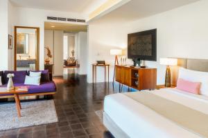 a bedroom with a bed and a living room at Viroth's Hotel in Siem Reap
