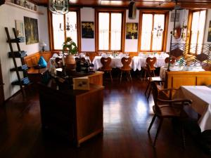 a restaurant with tables and chairs in a room at Hotel Restaurant Rössle in Calw