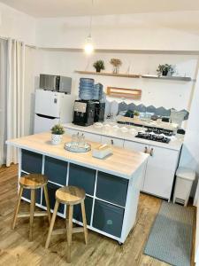 a kitchen with a counter and two stools at Casa Tosa Podomoro Golf View in Tjikuda Tiga