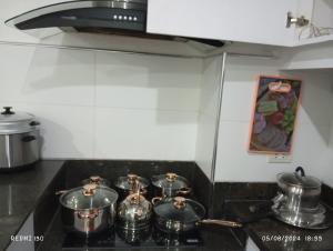 a group of pots on a stove in a kitchen at The Loft Nook in E-building Kiener Hills Condominium in Pusok