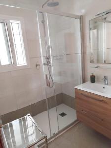 a bathroom with a shower and a sink at CASA DIEGO PUERTO BLANQUILLO in Frigiliana +18 photos
