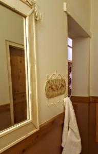 a bathroom with a mirror and a towel at Oregon Cottage in Ficksburg