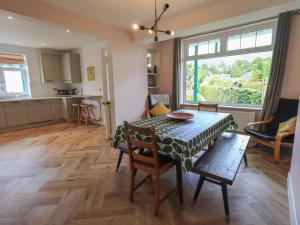 a kitchen and dining room with a table and chairs at Limhus House in Keswick